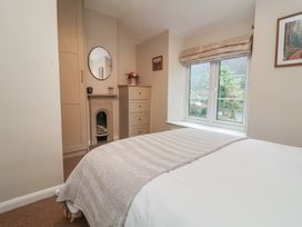 A bedroom with a bed and a window at Woodedge in Porlock