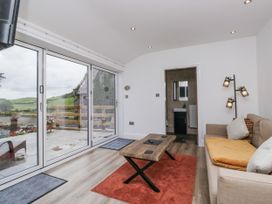 A snug with a sofa and coffee table at Holy Trinity Cottage in Millom