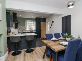 A dining room with a table and chairs at Holy Trinity Cottage in Millom