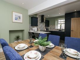 A dining area with chairs and table in Holy Trinity Cottage Millom