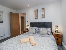 A bedroom with a bed and bedside tables at Holy Trinity Cottage in Millom