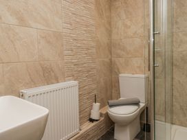 A bathroom with a shower and toilet at Holy Trinity Cottage in Millom