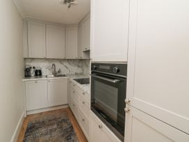 A kitchen with cabinets, sink and oven at 7 Belfort Court