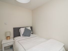 A bedroom with a bed and nightstand at 7 Belfort Court 