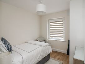 A bedroom with a bed and window at 7 Belfort Court