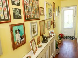 A hallway with frames and decor items at No.51 Llanteg Park in Amroth