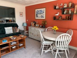A living room with a sofa table and chairs at No.51 Llanteg Park in Amroth