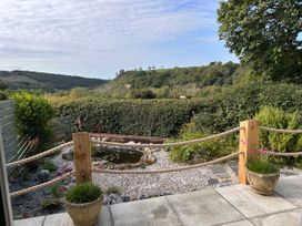 A garden with a pond and flowers at No.51 Llanteg Park in Amroth