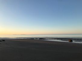 A beach with ocean and sky at No.51 Llanteg Park Amroth