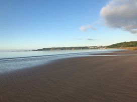 A beach with sand and water at No.51 Llanteg Park Amroth