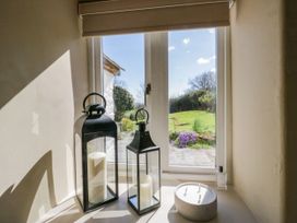 Interior with lanterns and view of garden at Barn Howe in Lyth near Levens