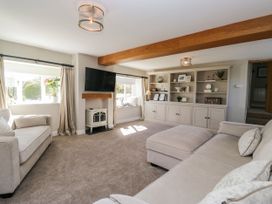 A living room with a sofa and shelving at Barn Howe Lyth near Levens