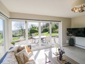 A living room with a sofa and a view of the garden at Barn Howe Lyth near Levens