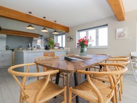 A dining room with a table and chairs at Barn Howe in Lyth near Levens