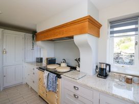 A kitchen with an oven and extractor hood at Barn Howe in Lyth near Levens