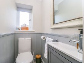 A bathroom with a toilet and sink at Barn Howe Lyth near Levens