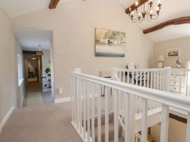 A hallway with staircase and console table at Barn Howe in Lyth near Levens