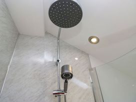 A shower with a rain shower head and a handheld shower at Barn Howe Lyth near Levens