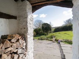 A view of a garden with a stone path and shrubs at Barn Howe in Lyth near Levens