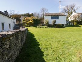A garden with grass and a house at Barn Howe in Lyth near Levens