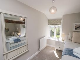 A bedroom with a bed and a lamp at Barn Howe in Lyth near Levens