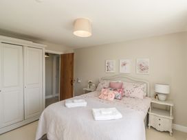A bedroom with a bed and wardrobe at Barn Howe Lyth near Levens