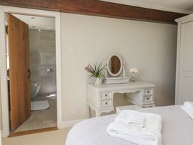 A bedroom with a desk and mirror at Barn Howe in Lyth near Levens