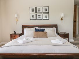 A bedroom with a bed and bedside table at Barn Howe in Lyth near Levens