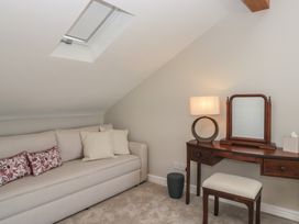 A dressing room with a sofa and vanity table at Barn Howe in Lyth near Levens