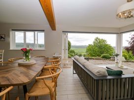 A dining room with a table and chairs at Barn Howe Lyth near Levens