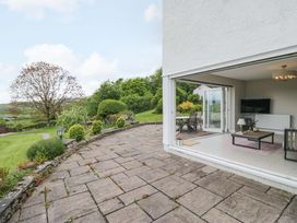 An outdoor patio area with furniture and a view at Barn Howe Lyth near Levens