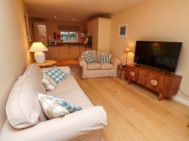 A living room with a sofa and television at High Sea View