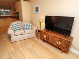 A living room with a sofa and television at High Sea View