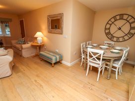 A living room with a sofa and dining area at High Sea View