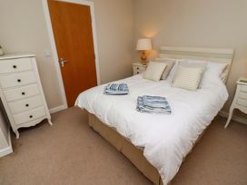 A bedroom with a bed and dresser at High Sea View