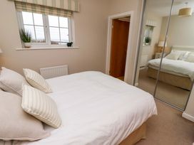 A bedroom with a bed and window at High Sea View