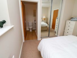 A bedroom with a bed and a view of a bathroom at High Sea View