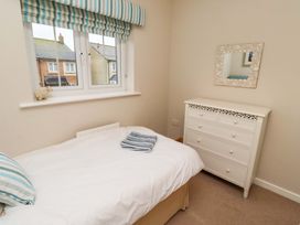 A bedroom with a bed and dressing table at High Sea View