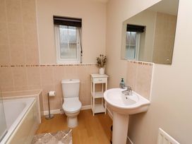 A bathroom with a sink, toilet, bathtub and window at High Sea View in 