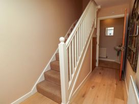 A hallway with stairs leading to the upper floor at High Sea View 