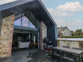 An outdoor dining area with a table and chairs at The Barn in Newport