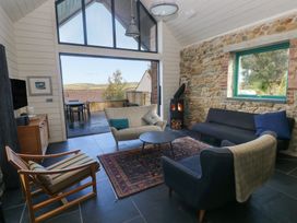 A living room with a fireplace and sofa at The Barn in Newport