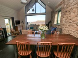 A dining room with a table and chairs at The Barn in Newport