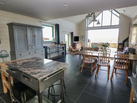 A kitchen with a dining area and island at The Barn in Newport