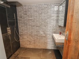 A bathroom with a shower and sink at The Barn in Newport