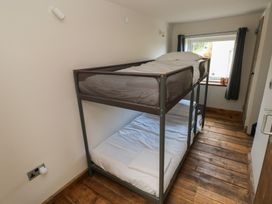 A bedroom with a bunk bed and a window at The Barn in Newport