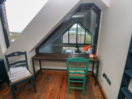 A study area with a desk and chair at The Barn in Newport