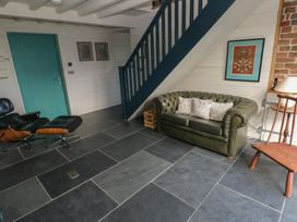 A living room with a sofa and a lamp at The Barn in Newport