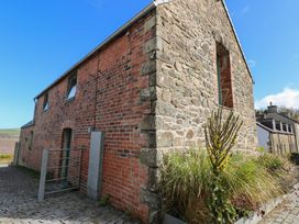 An outdoor area with a stone and brick building and a pathway at The Barn in Newport