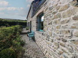 A garden view featuring a stone wall and pathway at The Barn in Newport